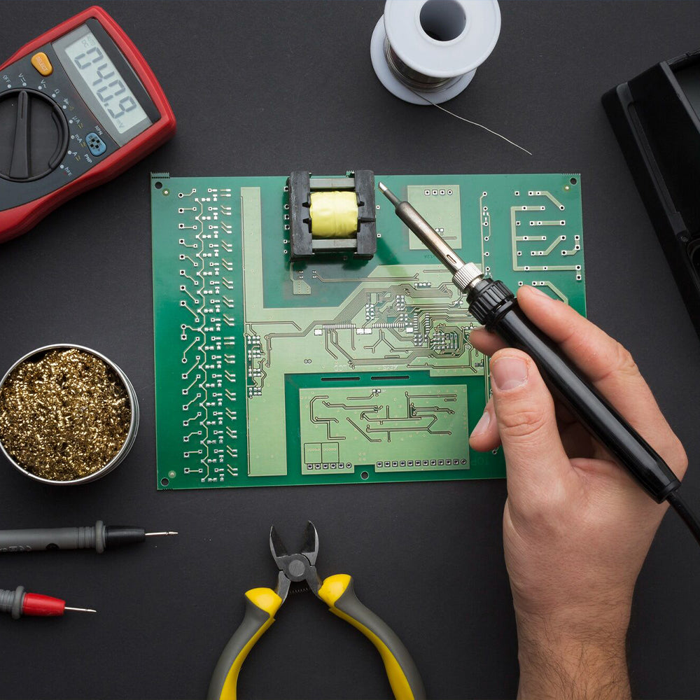 There is a PCB on the table about to be soldered, and there is a multimeter on the upper left.